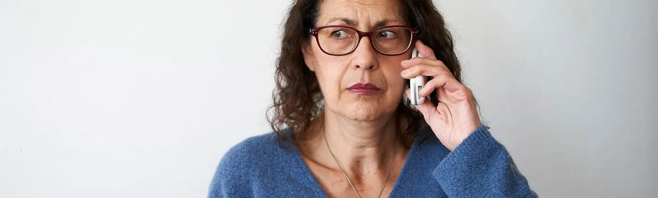 Mature woman distrusting phone call